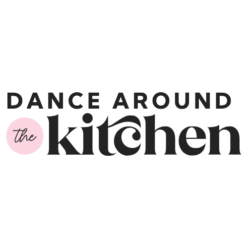 The logo reads "Dance Around the Kitchen" in bold black letters with a pink circle behind "the." The word "kitchen" has a stylized swirl design within the letters.